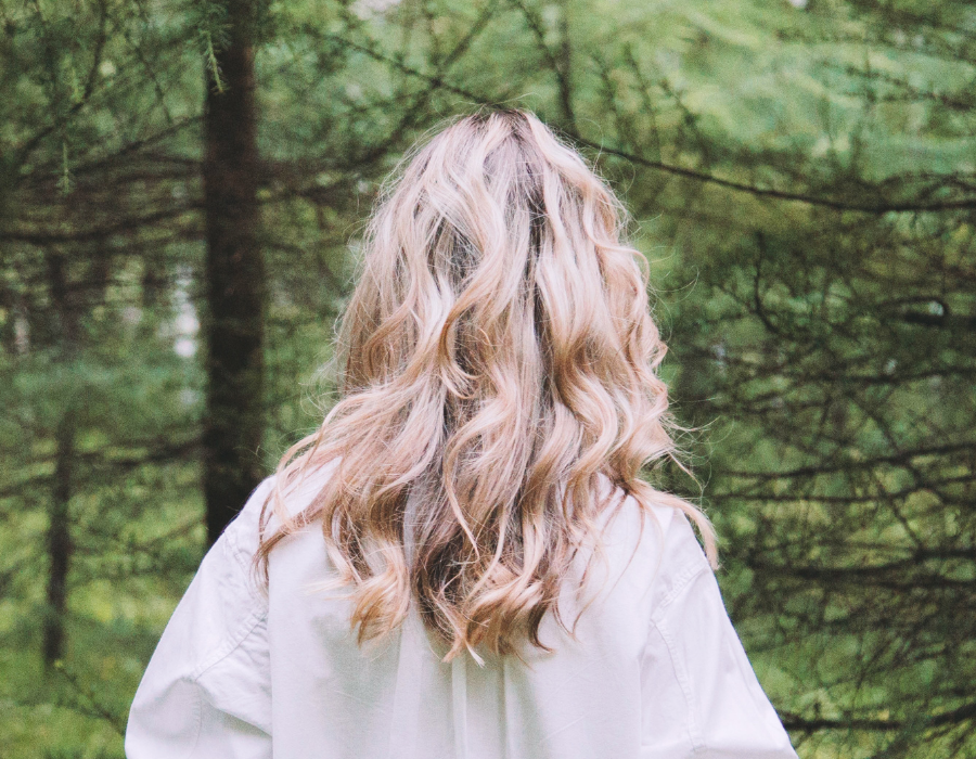 Blonde, curled, medium-length hair.